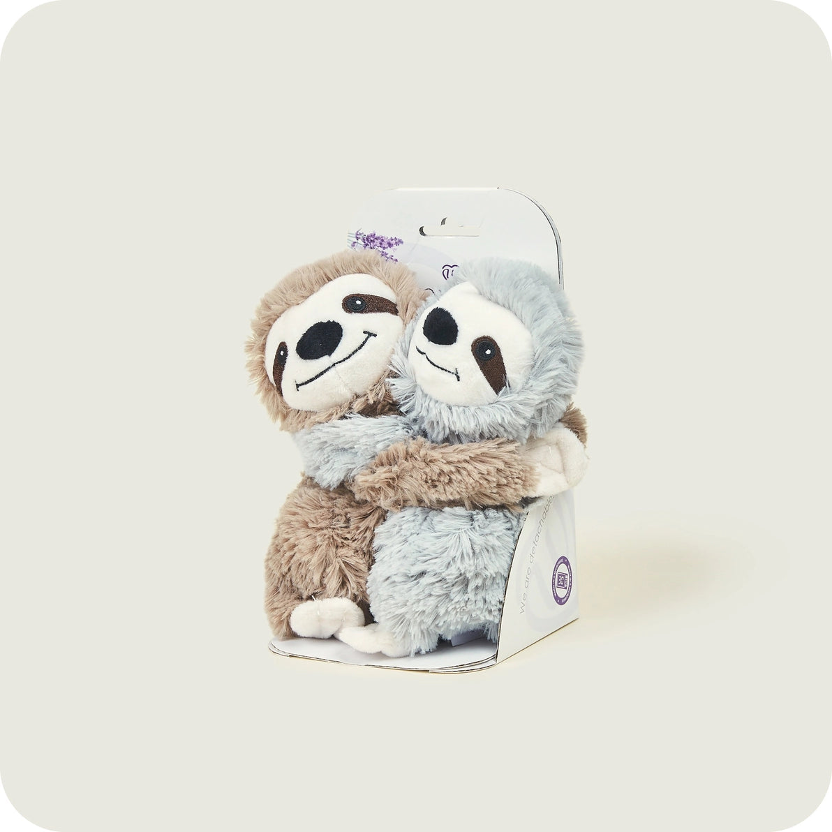 Two Warmies Warm Hugs Sloths in packaging, soft plush lavender-scented heatable toys.