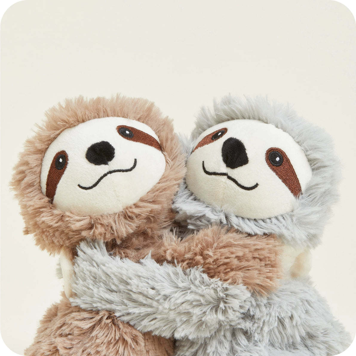 Close-up of Warmies Warm Hugs Sloths cuddling, heatable lavender plush toys.