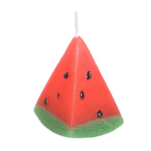 Close-up of a single watermelon slice candle with red body and green rind.