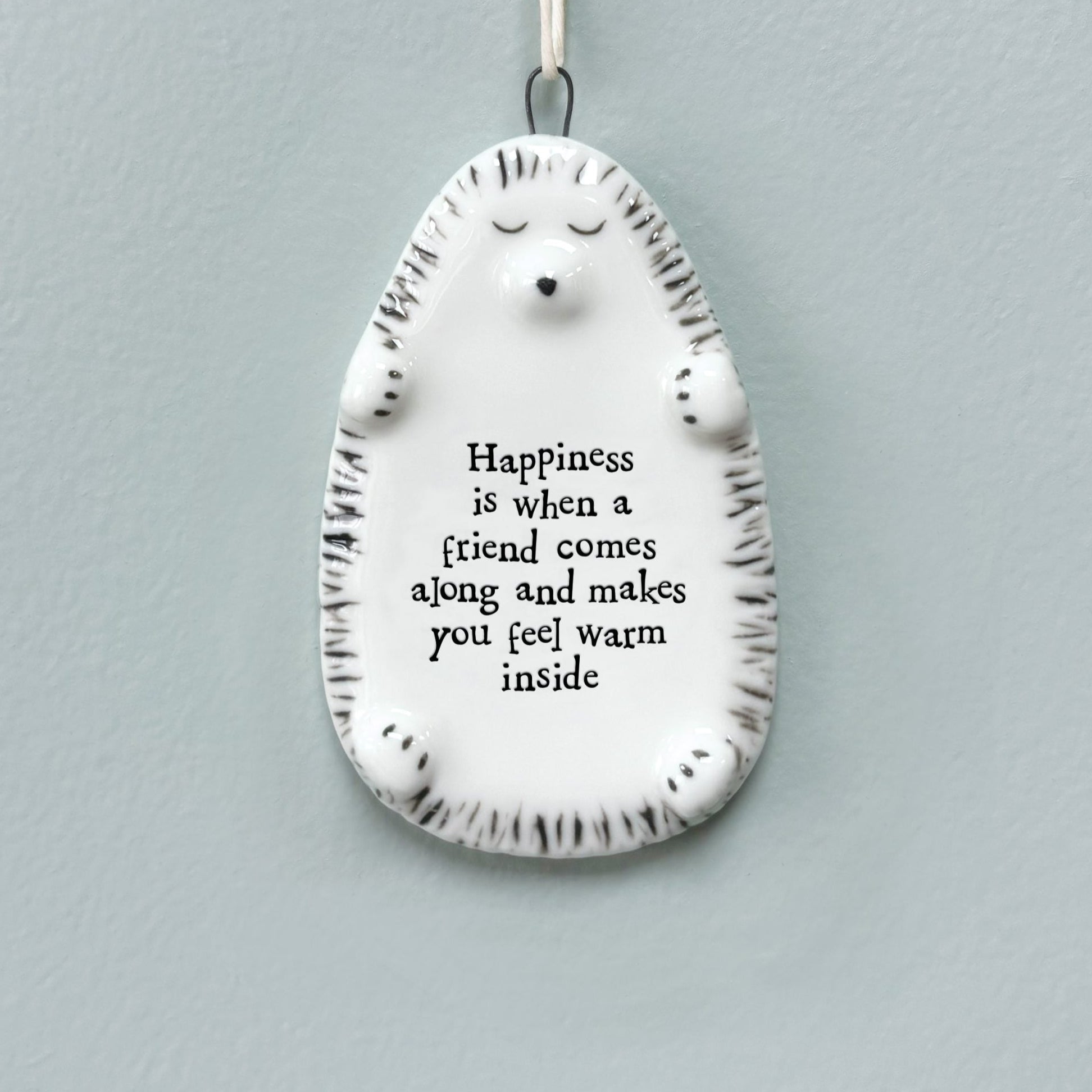 East of India porcelain hedgehog wall plaque with a heartfelt friendship quote - ‘Happiness is when a friend comes along and makes you feel warm inside.’ A thoughtful gift for friends and special occasions.