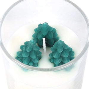 Top view of Winter Wonderland candle showing three detailed green wax trees set in creamy white paraffin.