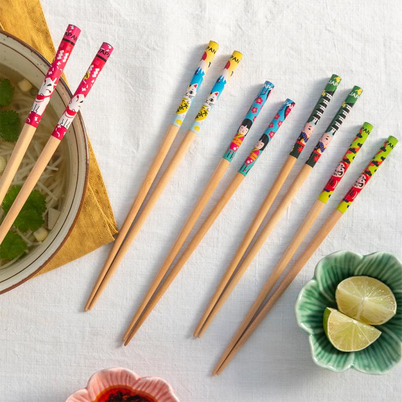 Five pairs of illustrated chopsticks showing colourful Japanese designs close-up