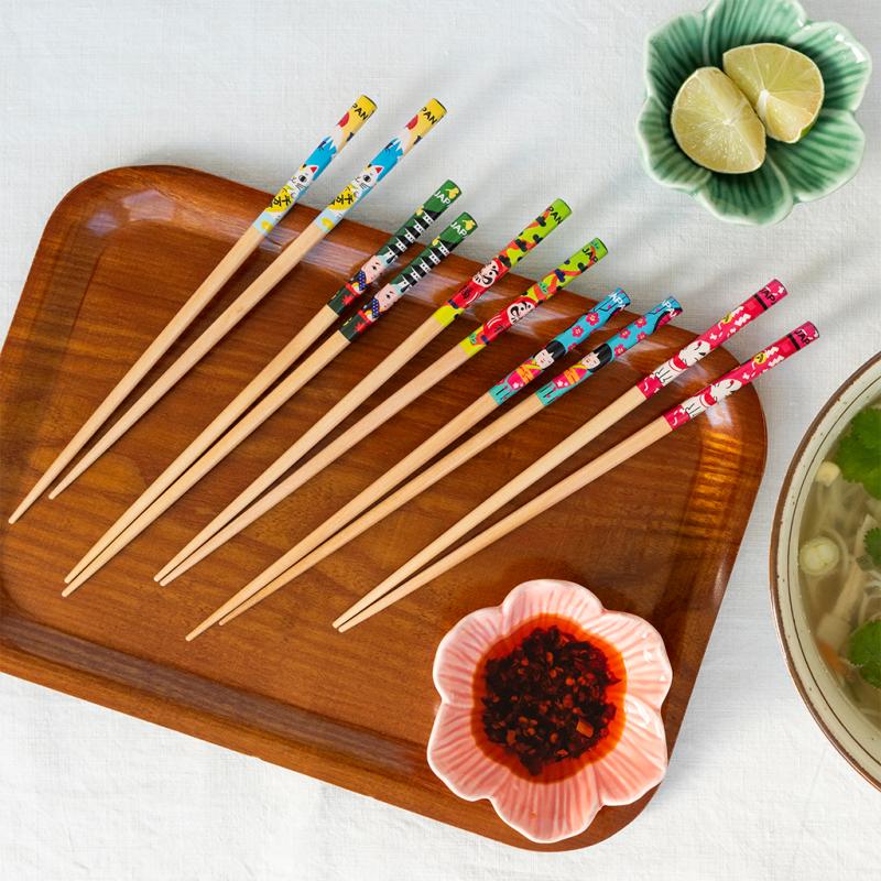 Japanese heritage wooden chopsticks fanned out on wooden tray with food styling