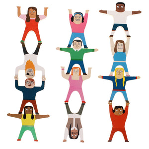 Wooden stacking characters arranged in tall towers showing balance play.