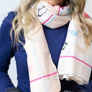 Woman styling the Woolly Ewe Scarf in a classic draped look, perfect for everyday wear.