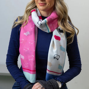 Model wearing the Woolly Ewe Scarf - Heather, showcasing its bright pink and blue design.