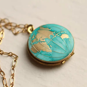 Handmade brass world map locket with turquoise enamel oceans and gold continents. A unique travel-inspired necklace with space for two photos inside.