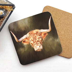 Rusty Rebel Highland Cow Coaster featuring a striking highland cow design by Gary Cox, placed on a white surface with a cork backing.