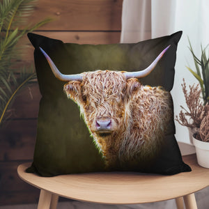 Twilight Highland Cow Suede Cushion on a wooden chair, featuring a detailed digital artwork of a Highland cow with curved horns against a dark background.