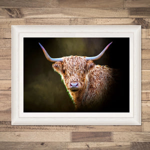 Framed Twilight Highland Cow Print – A framed giclée print of a Highland cow by Gary Cox, featuring a rich, moody background. Displayed on a wooden wall.