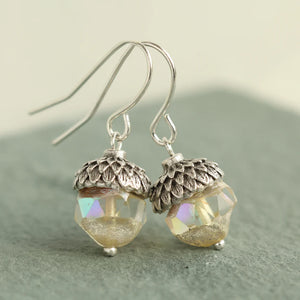 Handmade Yellow Opal Acorn Earrings hanging from shepherd’s crook ear wires