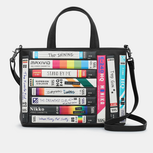 Front view of the Yoshi Be Kind Rewind Black Leather Multiway Grab Bag, showcasing the colourful VHS tape appliqué design.