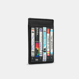 Side Angle: A side view of the cardholder showcasing its slim, compact shape and vibrant VHS artwork.