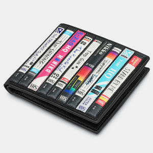 Closed Wallet: A flat lay image of the wallet closed, displaying the detailed video cassette spine design.