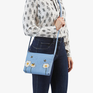 Worn look: Woman wearing the Yoshi Bee Happy crossbody bag styled with jeans and blouse.