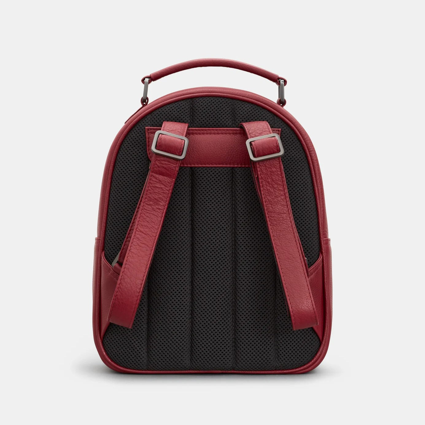 Cherry red leather backpack with padded black mesh back and adjustable shoulder straps.