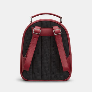 Cherry red leather backpack with padded black mesh back and adjustable shoulder straps.