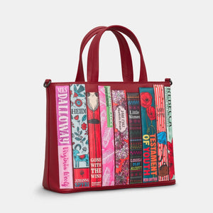 Cherry red leather book-themed handbag with top handles and colourful book spine detailing.