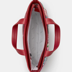 Inside of red leather book grab bag showing zip compartment, phone pocket, and slip pockets with branded lining.