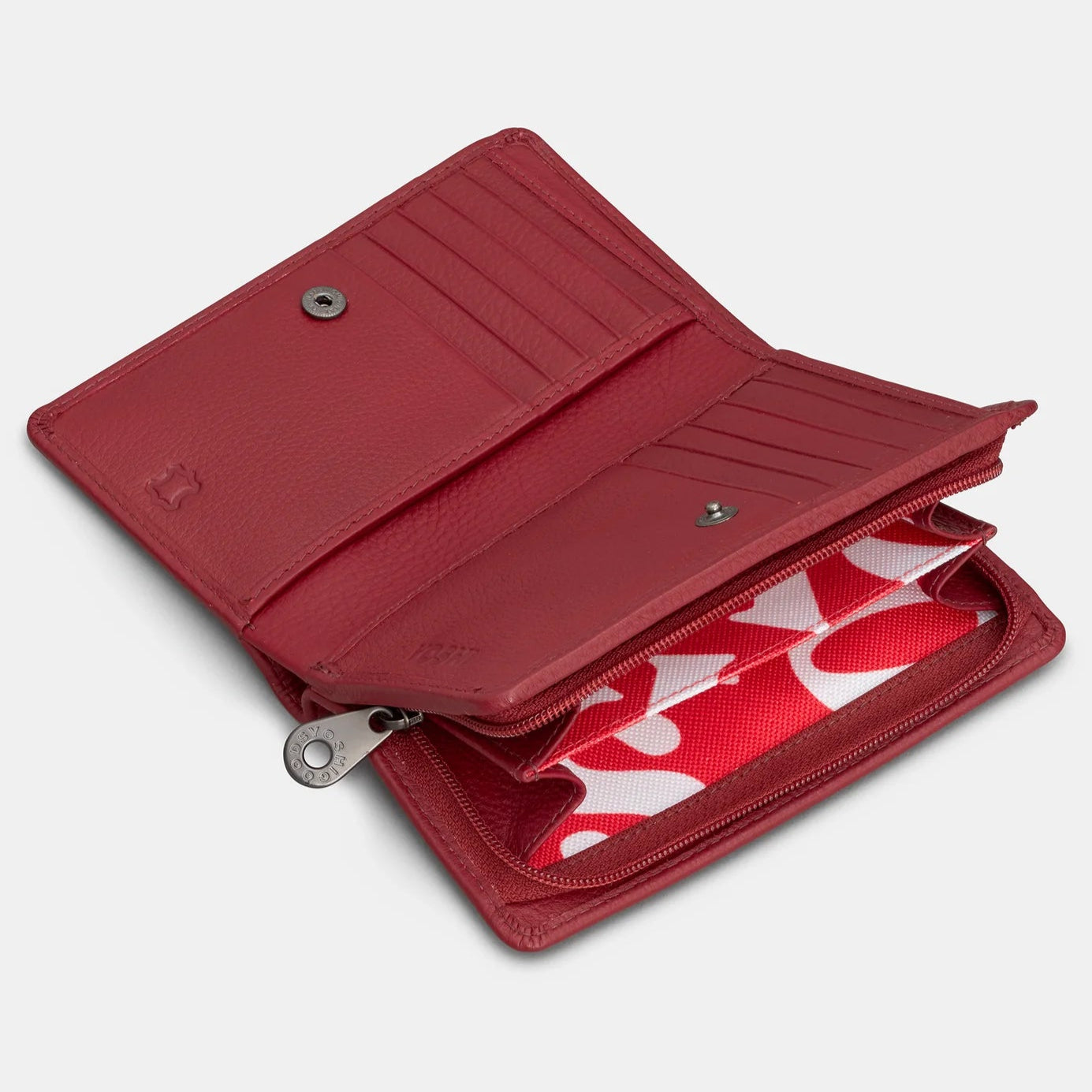 Angled view of cherry red leather purse partially open, displaying card slots and inner zipped compartment.