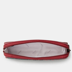 Open cherry red leather pencil case showing spacious fabric-lined interior.