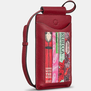 Side angle of cherry red leather phone pouch showcasing detailed book spine appliqué and slim profile.