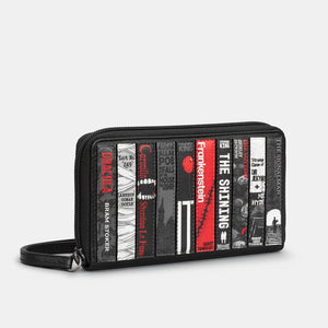 Side view of Horror Bookworm purse with wrist strap and detailed appliqué book design.