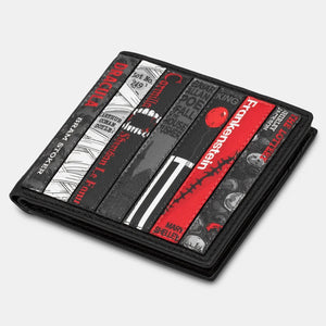 Closed black and red Yoshi leather wallet with horror classic book cover detailing lying flat on white background.