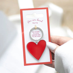 You Are Loved Keyring with red heart enamel charm on gift card packaging.