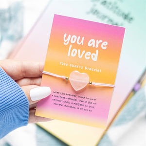 You Are Loved pink rose quartz heart bracelet on a branded card with affirmation text, perfect for gifting.