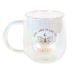 Front view of You Are Made of Magic Iridescent Double Walled Glass Mug showing gold text and celestial butterfly motif.
