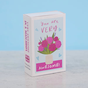 Front view of “You’re Very Awesome” matchbox gift with floral illustration and text.