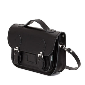 Side view of the Zatchels Black Leather Satchel in midi size with the shoulder strap behind. 