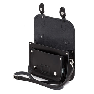 Inside the black leather midi satchel showing the internal pockets and fasteners.