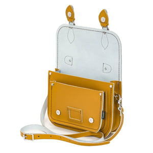 Inside the yellow leather satchel. This image shows both internal pockets and has a removable shoulder strap.
