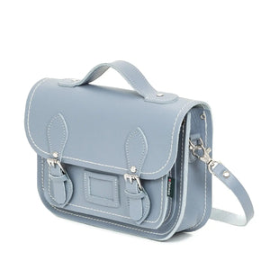 Side view of the lilac grey satchel with the shoulder strap off to the side.