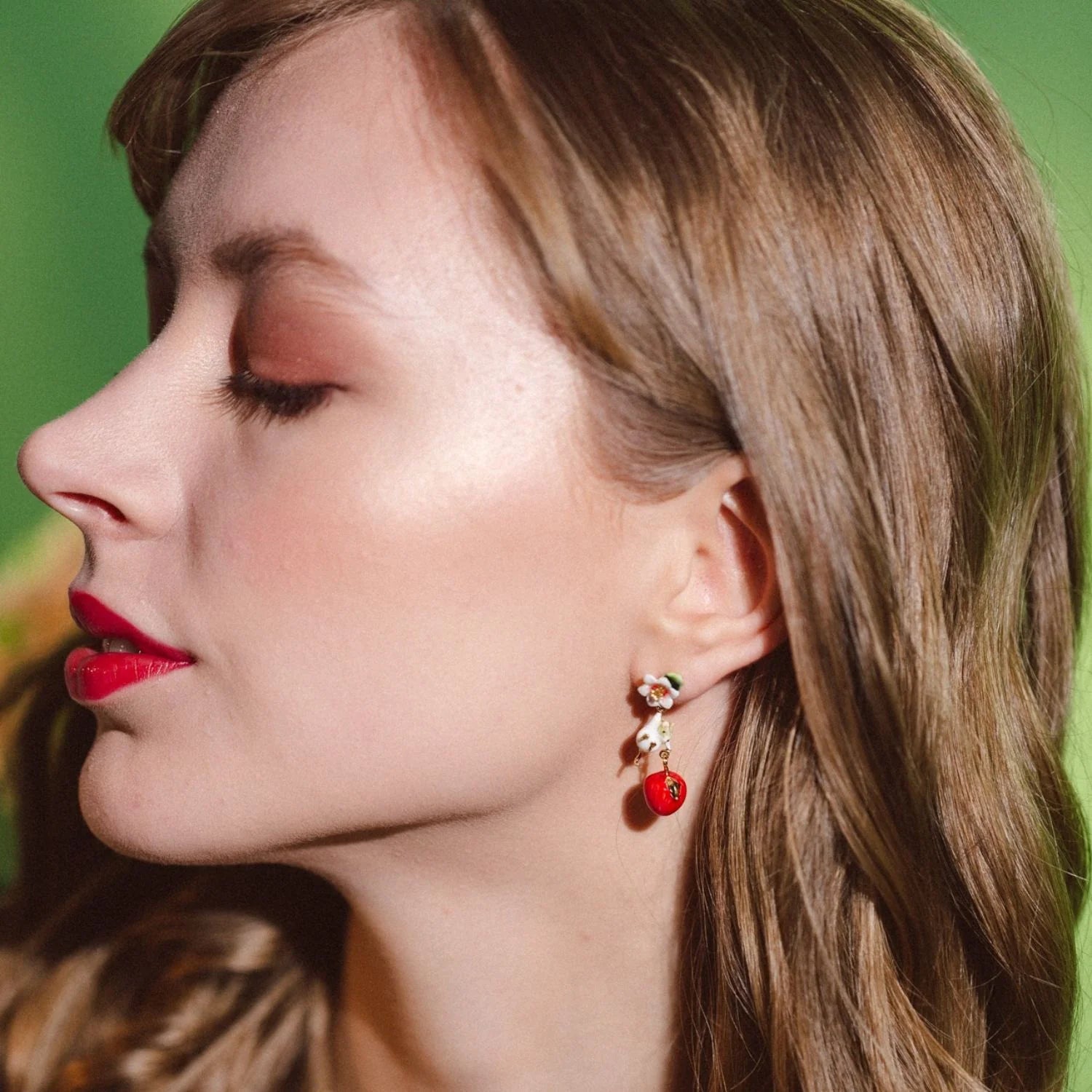 Close-up of Apple Blossom & Mouse Drop Earrings worn, showing mouse and apple detail.
