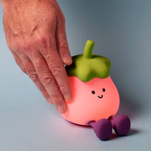 Hand tapping the soft-touch Aubergine Night Light to adjust the brightness.