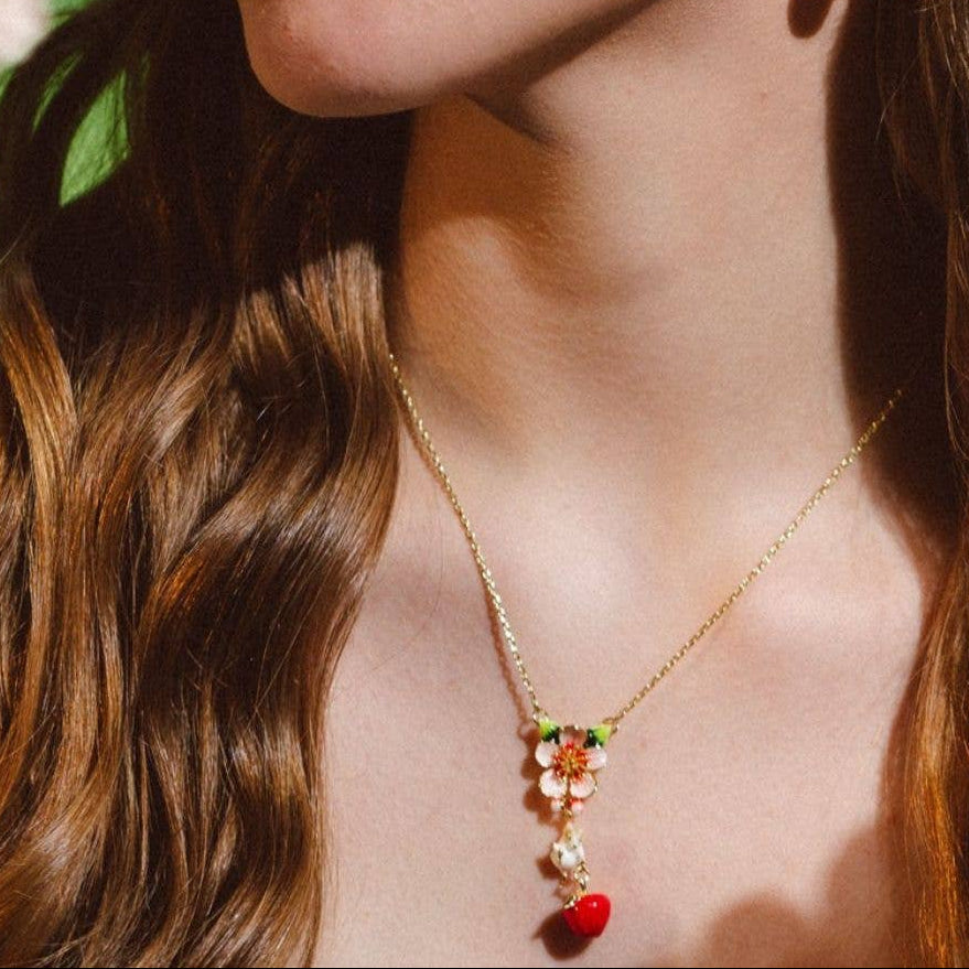 Model styling Apple & Mouse Blossom Pendant with matching earrings from Bill Skinner Jewellery collection.