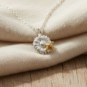 Two-tone flower and bee pendant with gold and silver detail