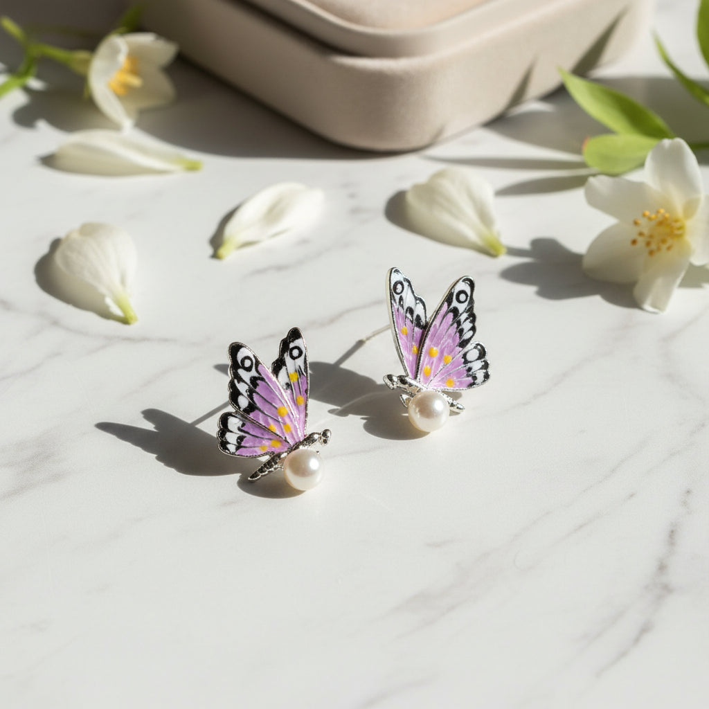 Half Butterfly and Pearl stud earrings with gold butterfly wing and pearl.