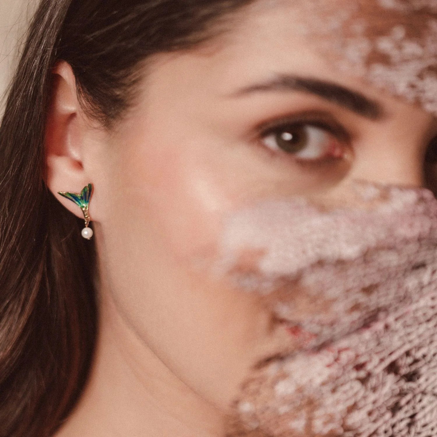 Model wearing Bill Skinner Mermaid Tail Stud Earrings featuring hand-painted enamel and pearl detail, inspired by ocean beauty.