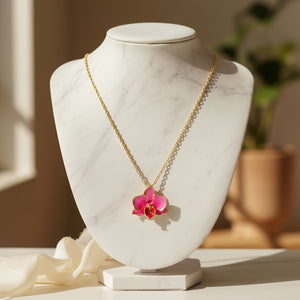 Orchid pendant charm with pink and purple enamel flower design.