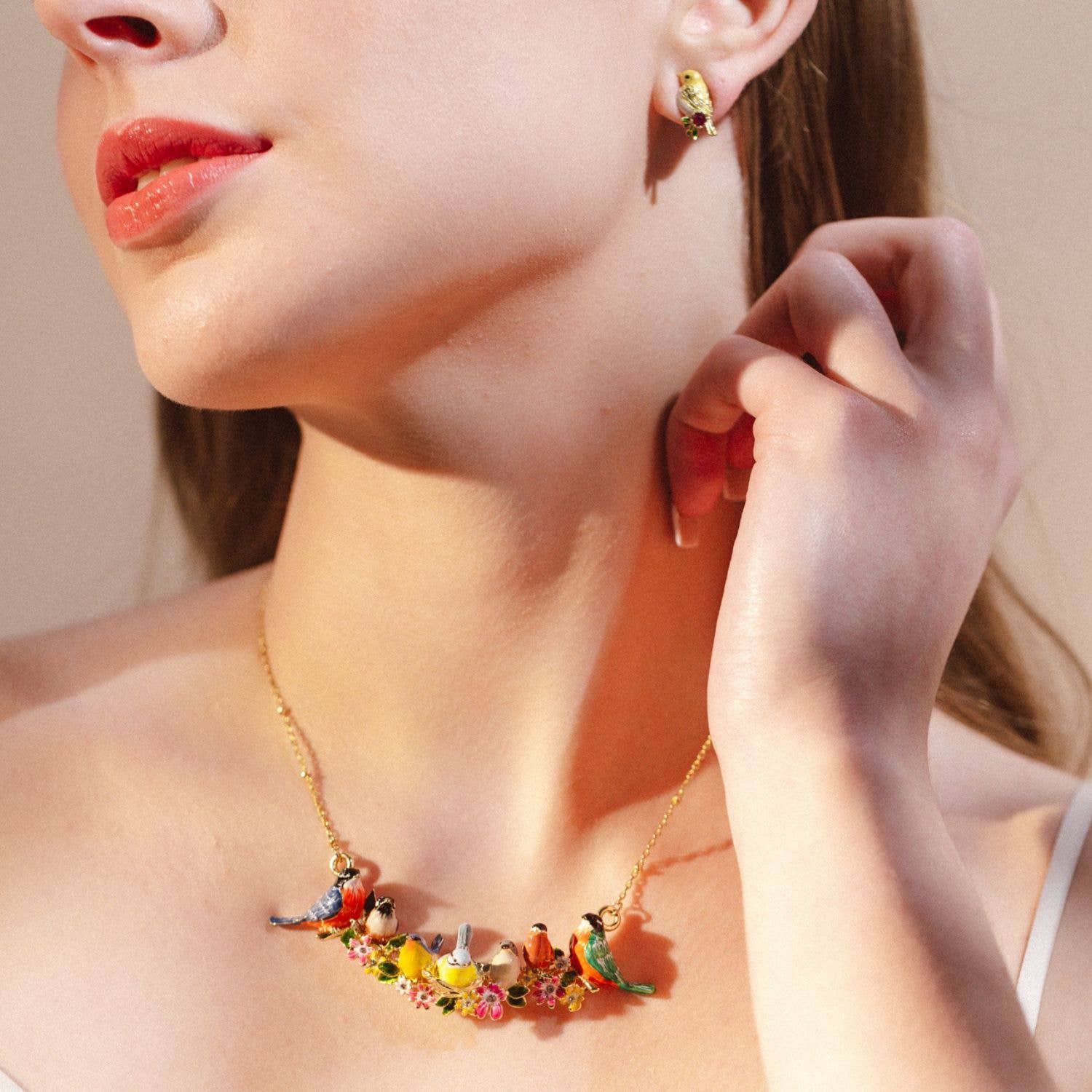Close-up of Songbird Serenade Necklace styled with matching earrings.