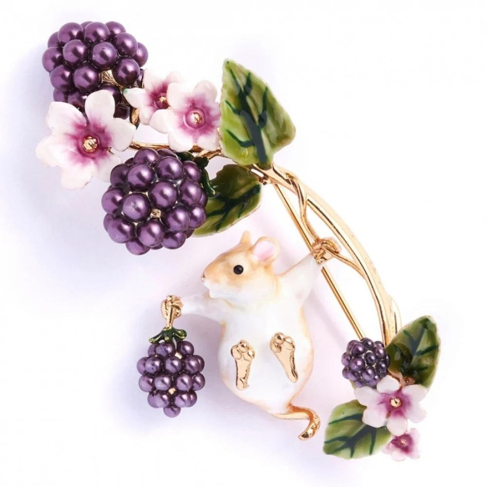 Close-up of Bill Skinner Blackberry & Mouse Brooch featuring hand-painted field mouse holding pearlised blackberries with enamel flowers.