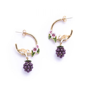 Close-up of Blackberry & Mouse Hoop Earrings with gold hoops, enamel mouse, and dangling blackberry pearls by Bill Skinner.
