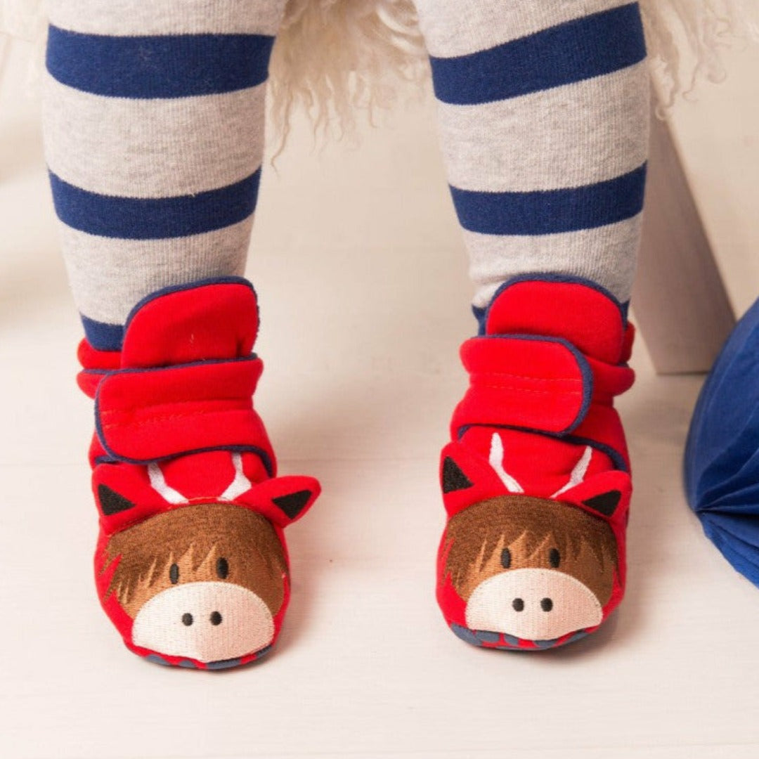 Baby wearing red Hamish highland cow booties with outfit