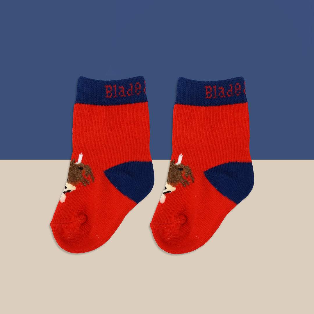 Red highland cow socks pair flat lay on beige background