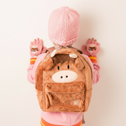 Child wearing brown fleece highland cow rucksack, rear view
