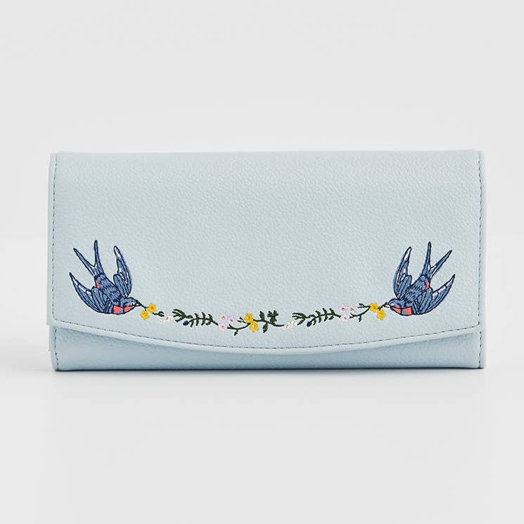 Light blue foldover purse with embroidered birds and floral garland.